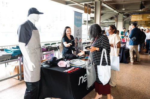 Suppliers showcase their innovative products on the concourse of Truist Field in Charlotte as part of Eurest and ESFM's Supplier Diversity Summit.