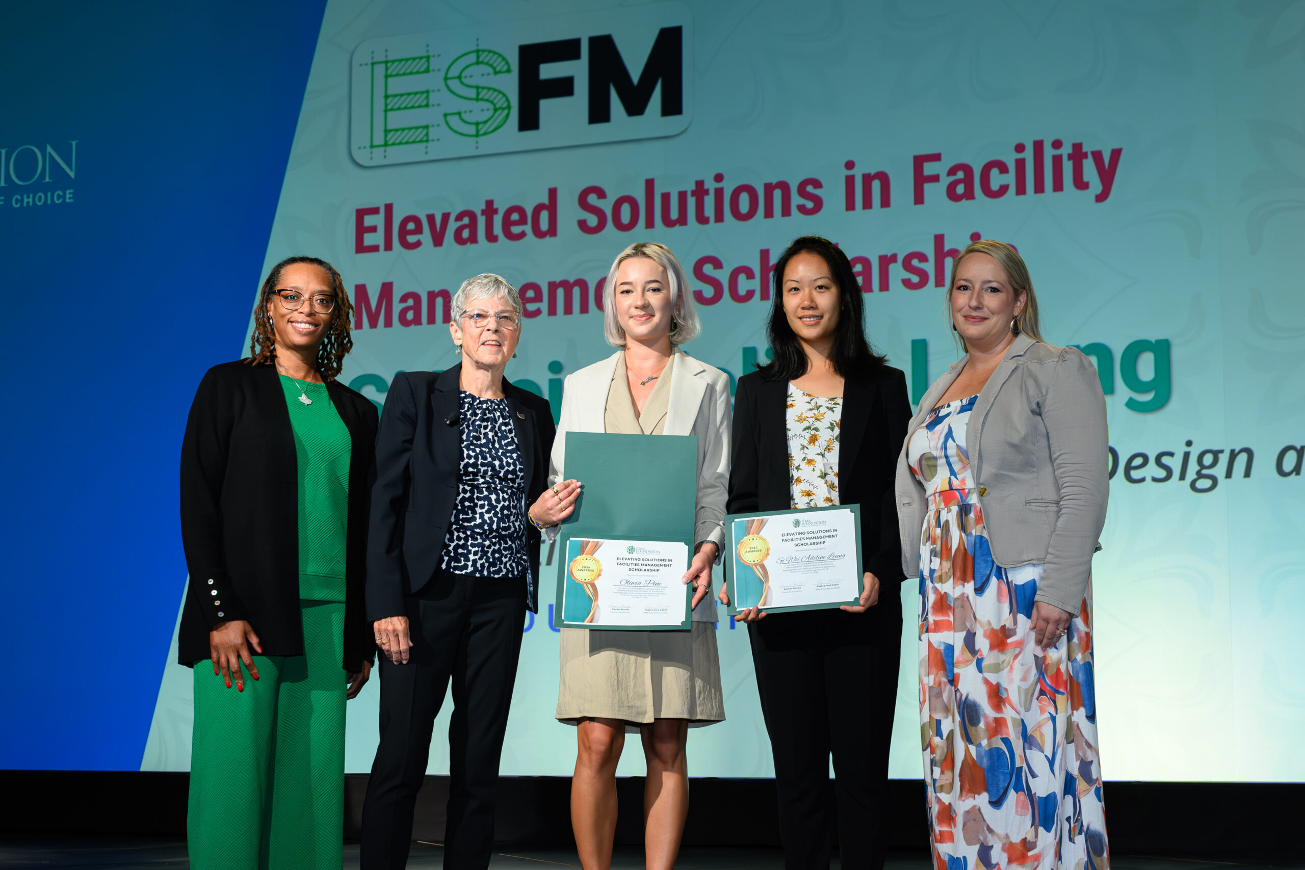 Lawyna Holland-Parish and Andrea Rossitter present the 2024 Elevating Solutions in Facilities Management scholarships to the winners along with an IFMA representative.